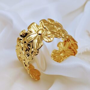 Jhunkaar Golden Floral Cuff Bracelet on a silk fabric