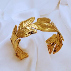 Gold wide cuff bracelets featuring a bold and chunky design, perfect for making a stylish statement.