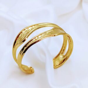 Introducing our stunning gold wide cuff bracelets, designed to make a statement with their bold and chunky silhouette. These eye-catching accessories are perfect for elevating any outfit, whether you're dressing up for a special occasion or adding flair to your everyday look. With their striking design, these bracelets effortlessly blend style and elegance, making them a must-have addition to your jewelry collection. Embrace the art of accessorizing and let these cuffs be the focal point of your ensemble!